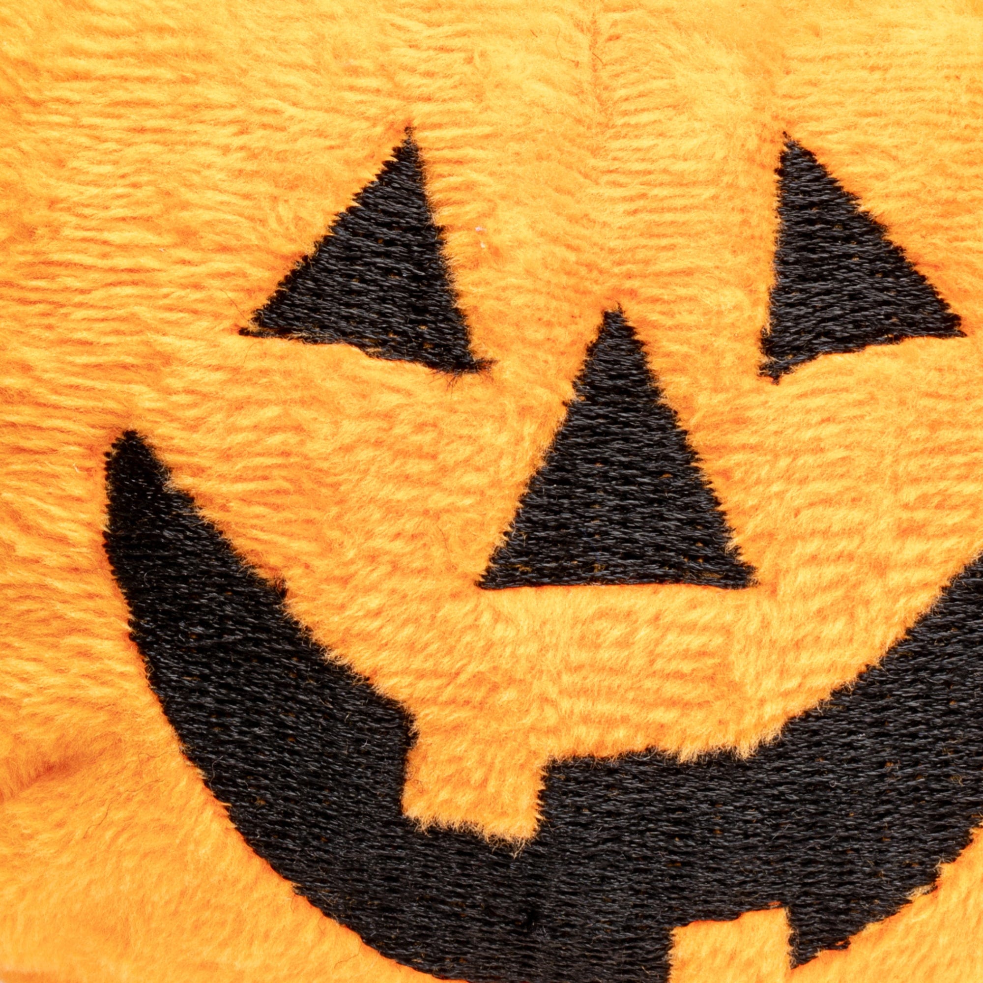 close up of orange pumpkin faball® with a happy jack-o-lantern face